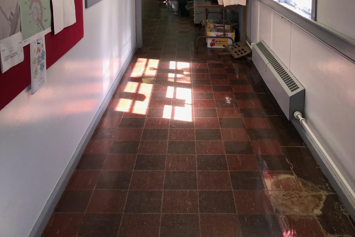 Damaged floor exposing asbestos